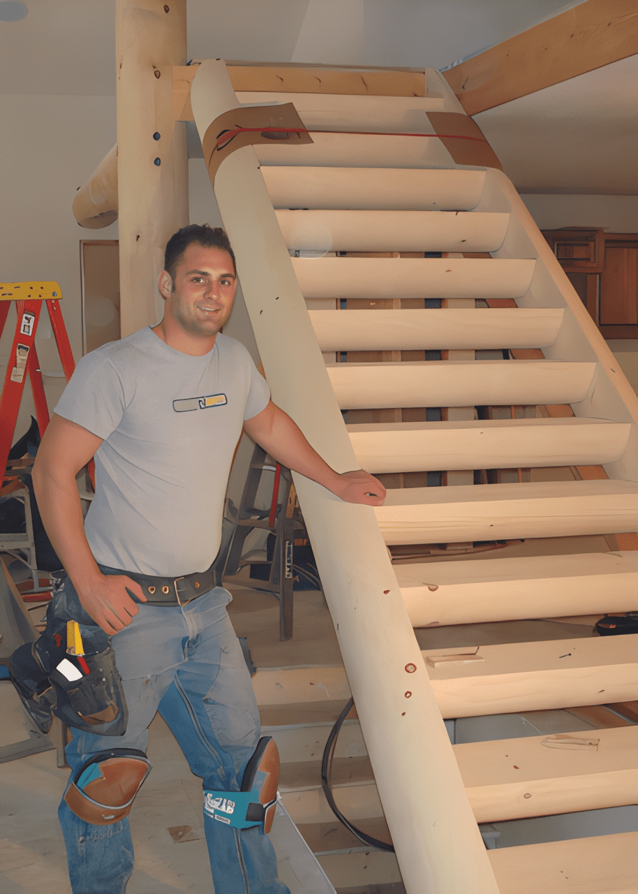 Builder next to unfinished staircase